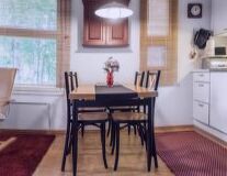 a kitchen with a dining room table in front of a window
